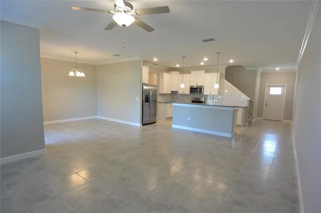 a view of a kitchen with a sink stainless steel appliances and cabinets