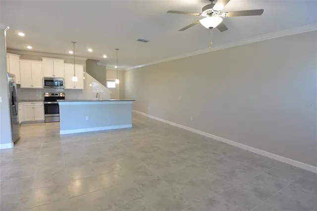 a view of a kitchen with a sink stainless steel appliances and cabinets