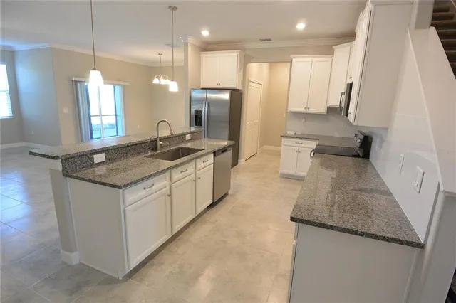 a bathroom with a granite countertop sink a toilet a mirror and vanity