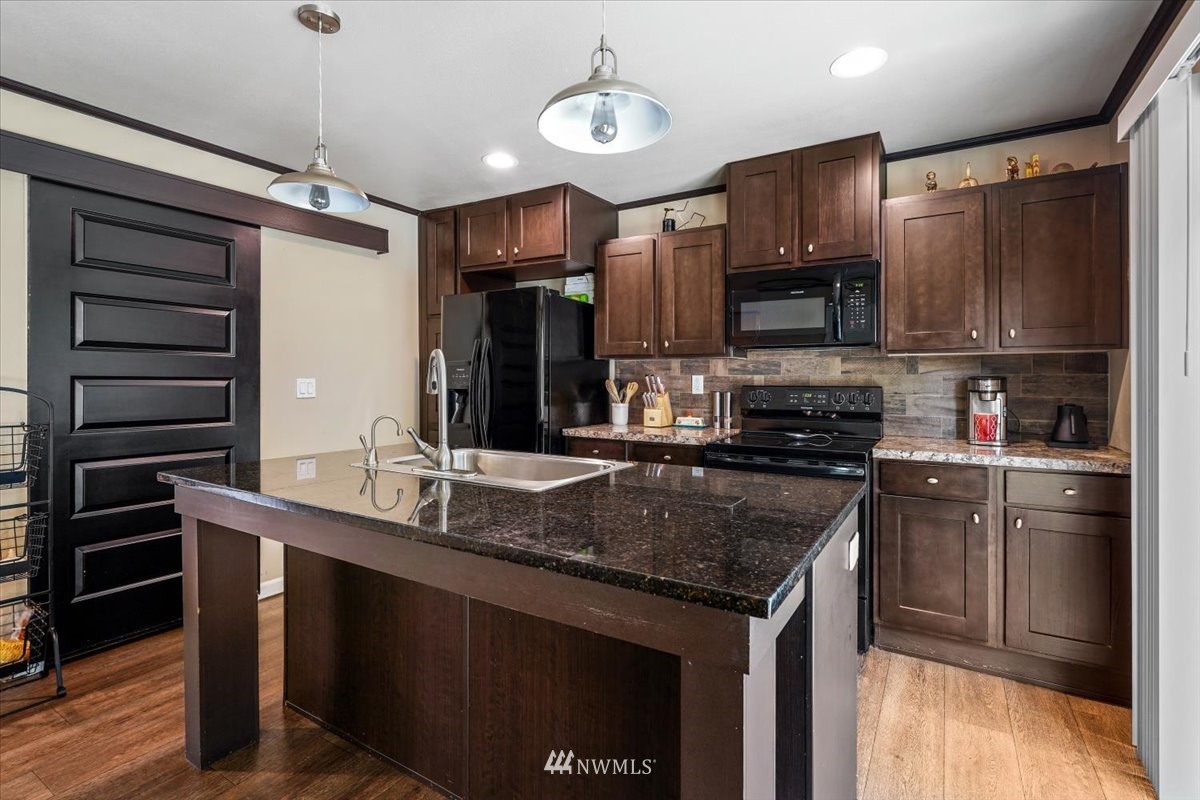 503 Maple Street Pe Ell, WA 98572 - Photo 15 of 27 a kitchen with stainless steel appliances granite countertop a sink stove and refrigerator