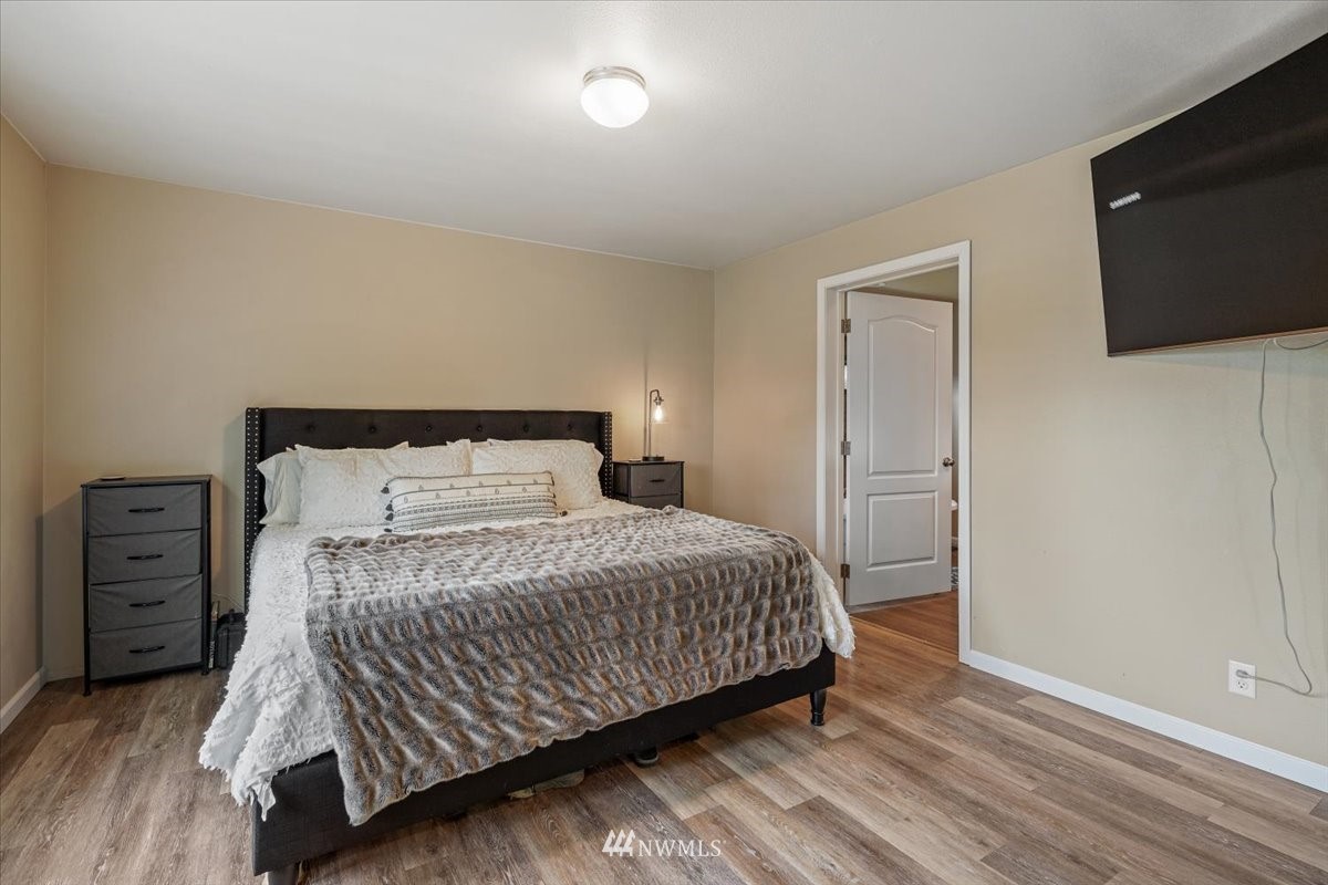503 Maple Street Pe Ell, WA 98572 - Photo 20 of 27 a bedroom with a bed and a flat screen tv