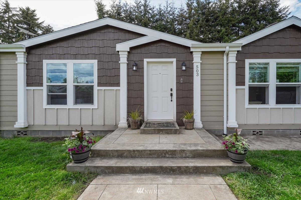503 Maple Street Pe Ell, WA 98572 - Photo 2 of 27 a front view of a house with garden