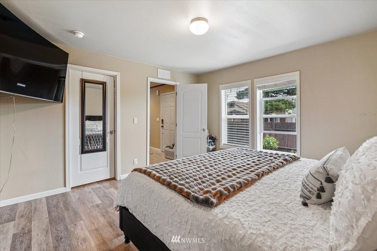 503 Maple Street Pe Ell, WA 98572 - Photo 21 of 27 a bedroom with a bed and wooden floor