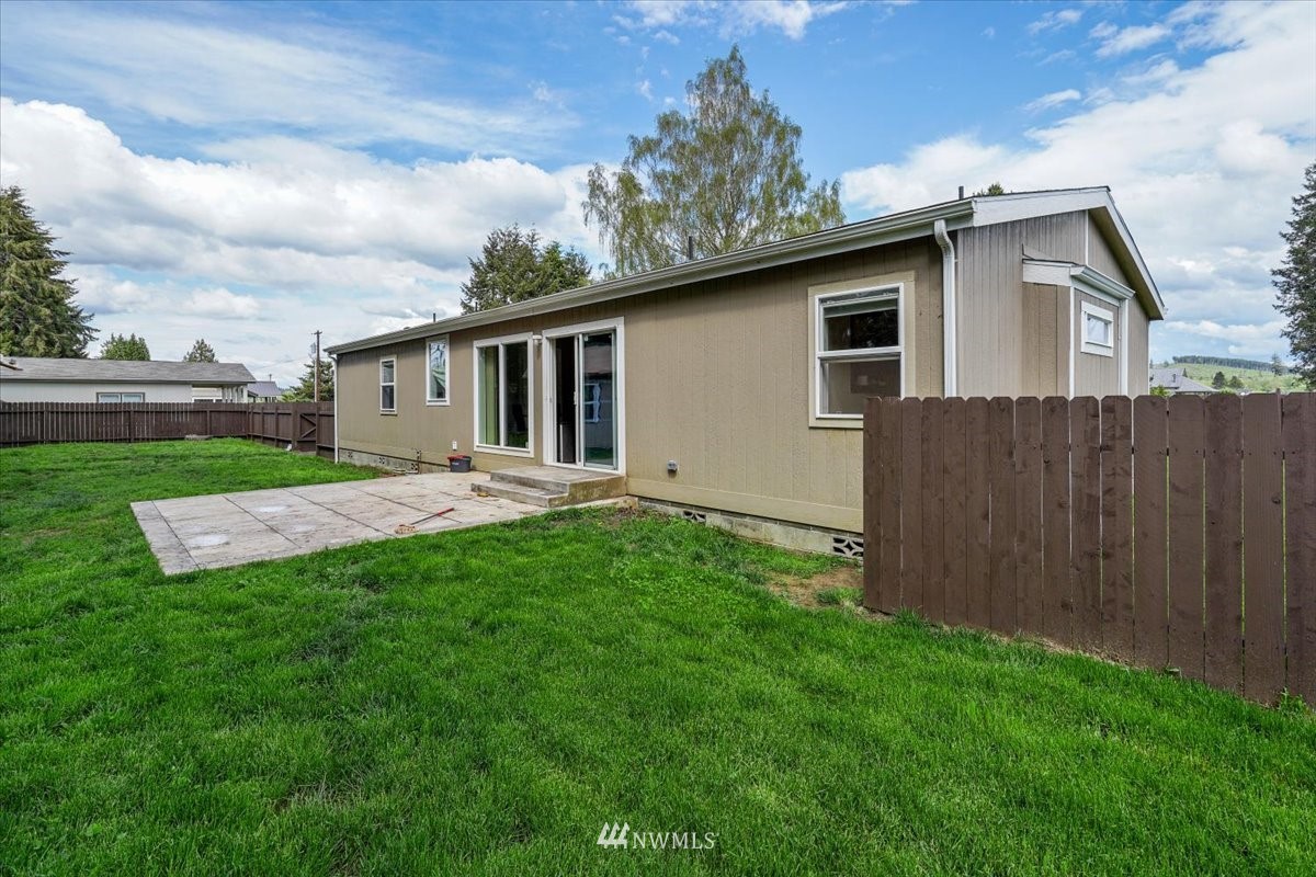 503 Maple Street Pe Ell, WA 98572 - Photo 25 of 27 a view of backyard with barbeque grill and wooden fence