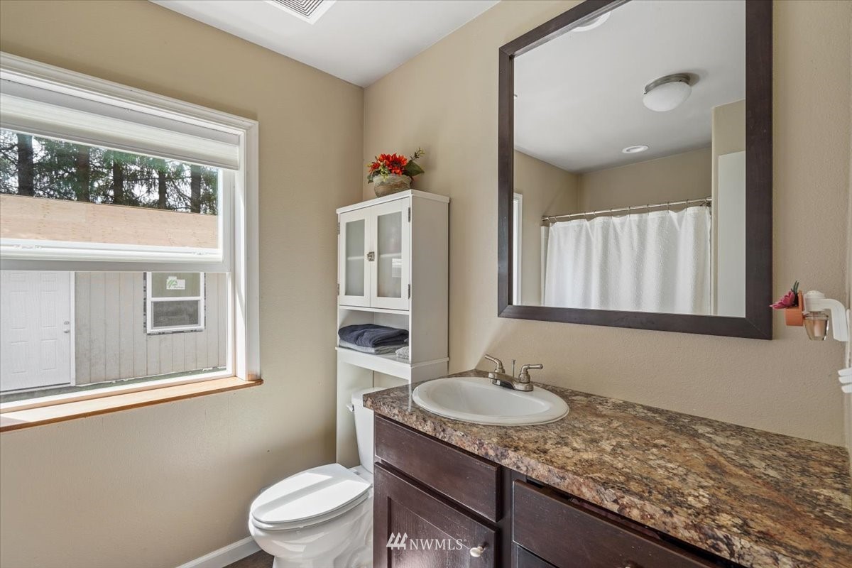503 Maple Street Pe Ell, WA 98572 - Photo 6 of 27 a bathroom with a granite countertop sink and a mirror