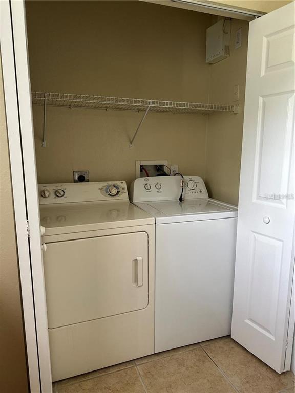 10112 Courtney Palms Boulevard, Unit 201 Tampa, FL 33619 - Photo 14 of 15 a utility room with dryer and washer