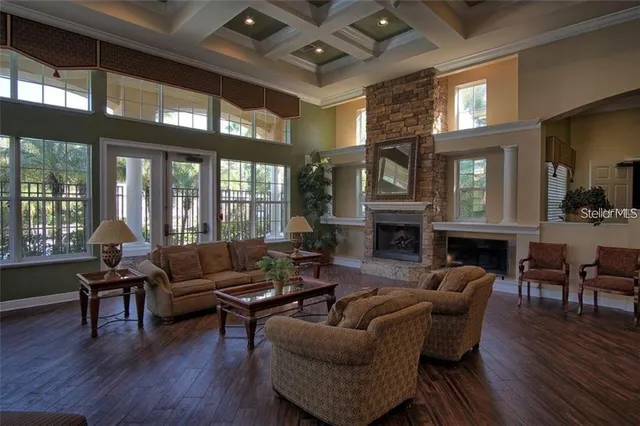 a living room with fireplace furniture and a large window