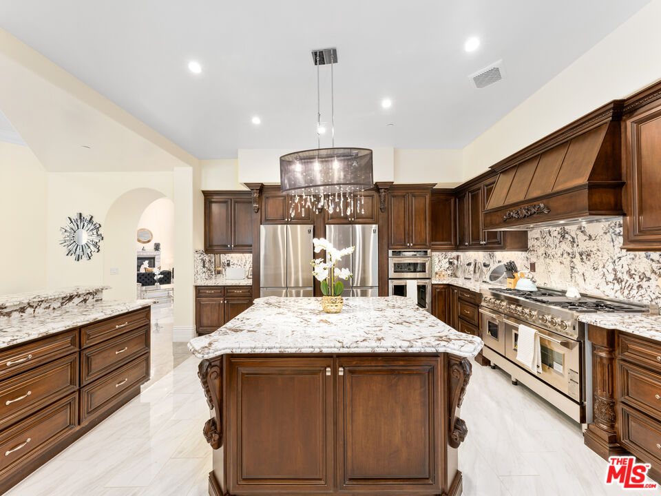 14420 Merlot Court Riverside, CA 92508 - Photo 22 of 57 a kitchen with stainless steel appliances granite countertop a sink stove and refrigerator