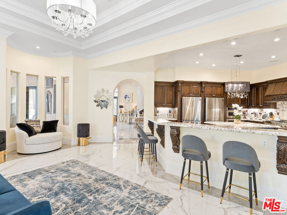 14420 Merlot Court Riverside, CA 92508 - Photo 25 of 57 a living room with kitchen island furniture and a chandelier