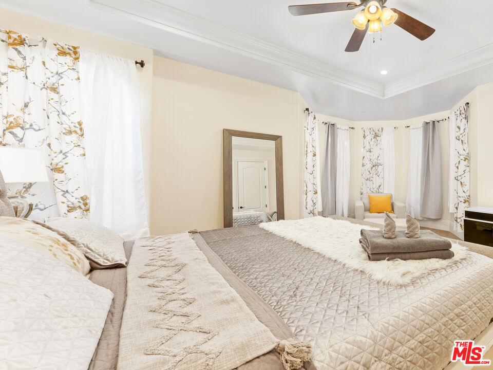 14420 Merlot Court Riverside, CA 92508 - Photo 34 of 57 a bedroom with a bed and a chandelier