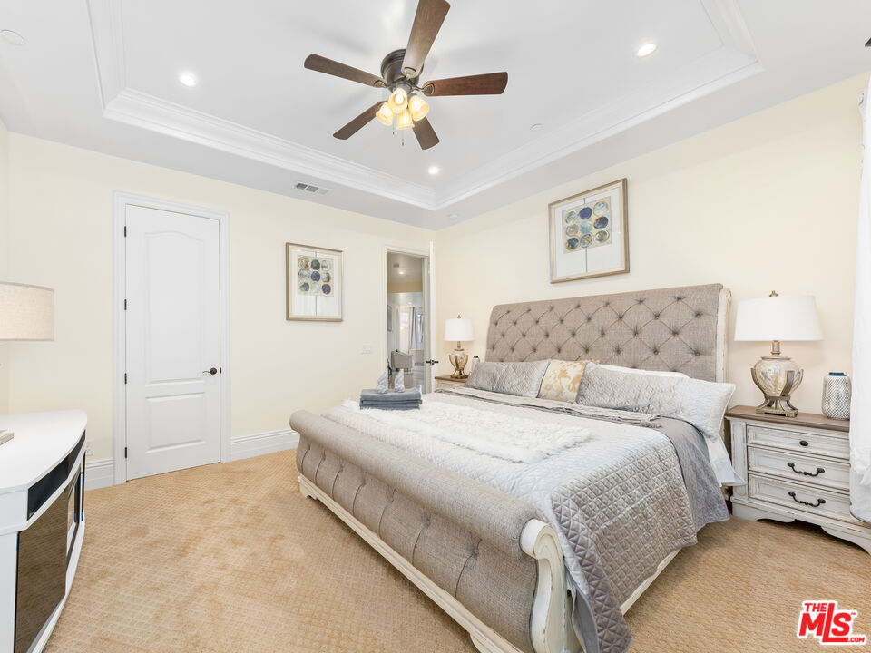 14420 Merlot Court Riverside, CA 92508 - Photo 35 of 57 a spacious bedroom with a bed and a chandelier