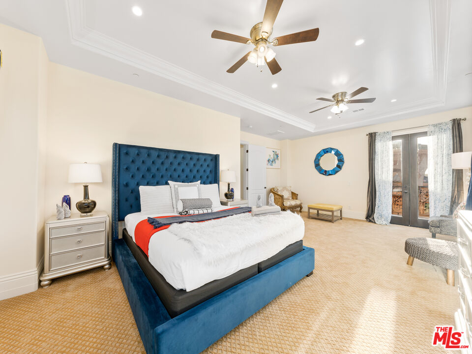 14420 Merlot Court Riverside, CA 92508 - Photo 42 of 57 a bedroom with a bed ceiling fan and a large window