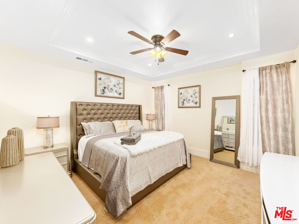 14420 Merlot Court Riverside, CA 92508 - Photo 46 of 57 a bedroom with a bed and a chandelier