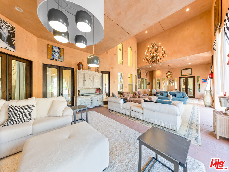 14420 Merlot Court Riverside, CA 92508 - Photo 51 of 57 a living room with furniture a large window and chandelier