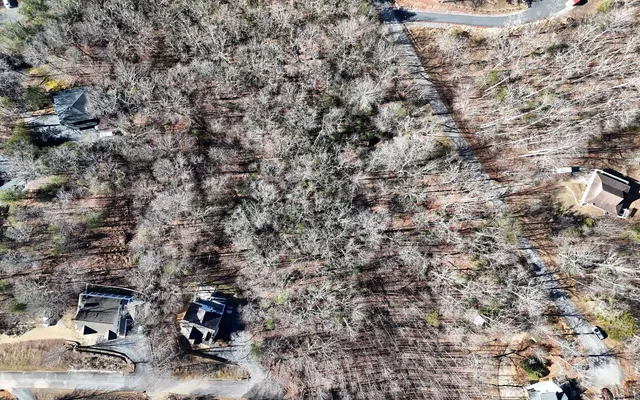 an aerial view of residential house and sandy dunes