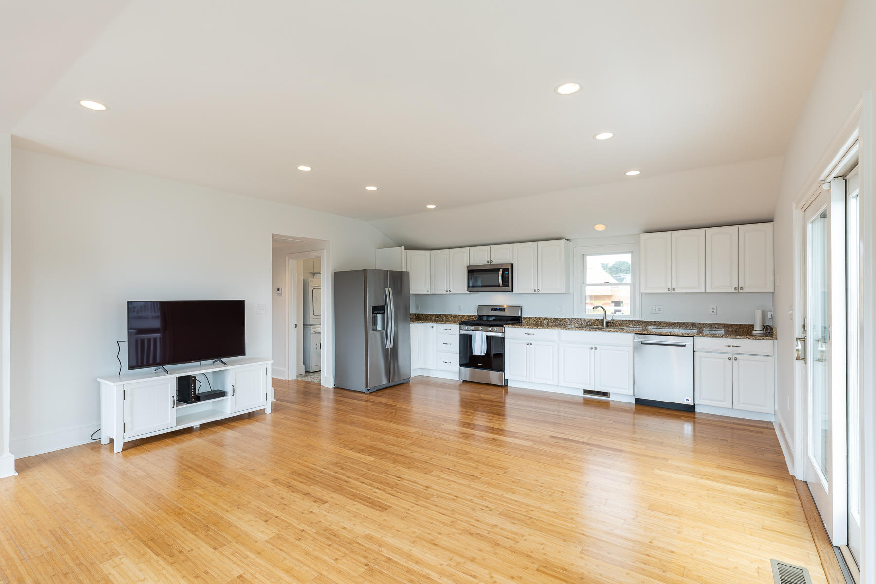 46 Surfside Road West Dennis, MA 02670 - Photo 13 of 32 a large white kitchen with kitchen island a sink and a stove top oven