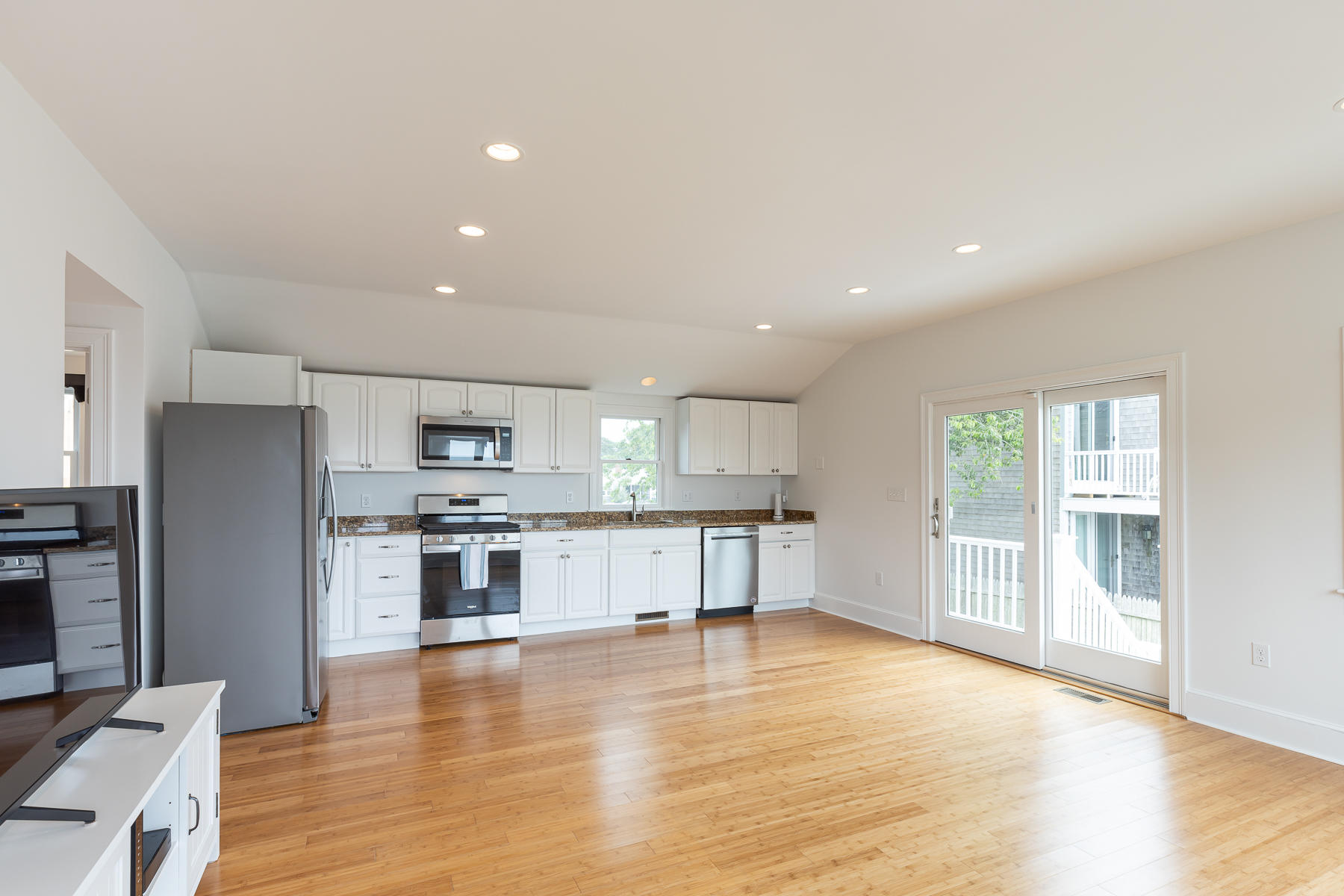 46 Surfside Road West Dennis, MA 02670 - Photo 15 of 32 a large kitchen with stainless steel appliances granite countertop a refrigerator and a stove top oven