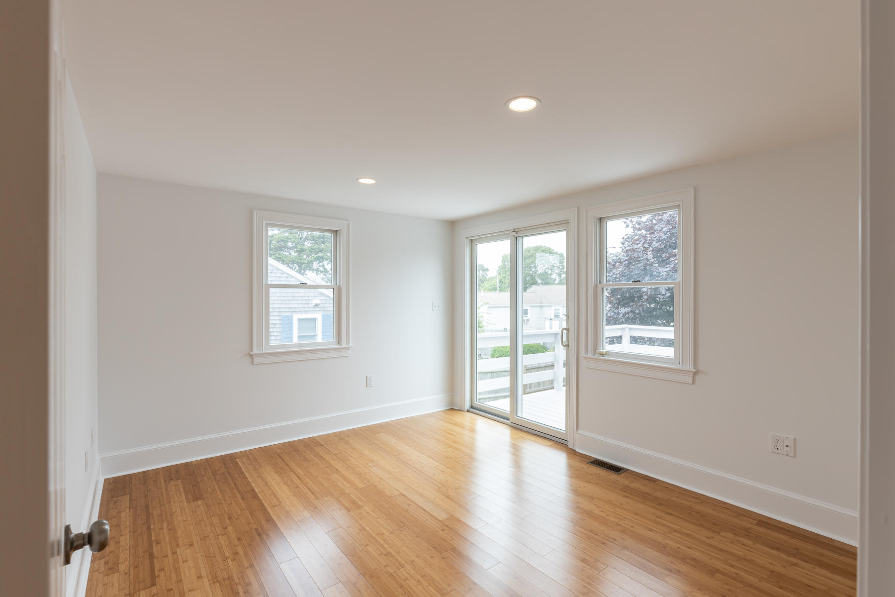 46 Surfside Road West Dennis, MA 02670 - Photo 17 of 32 an empty room with wooden floor and windows
