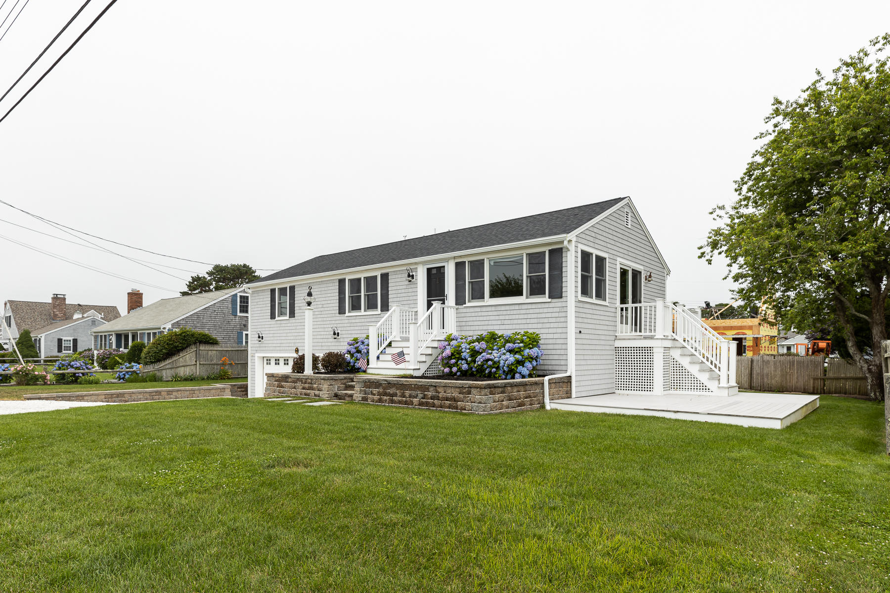 46 Surfside Road West Dennis, MA 02670 - Photo 2 of 32 a front view of house with yard and green space