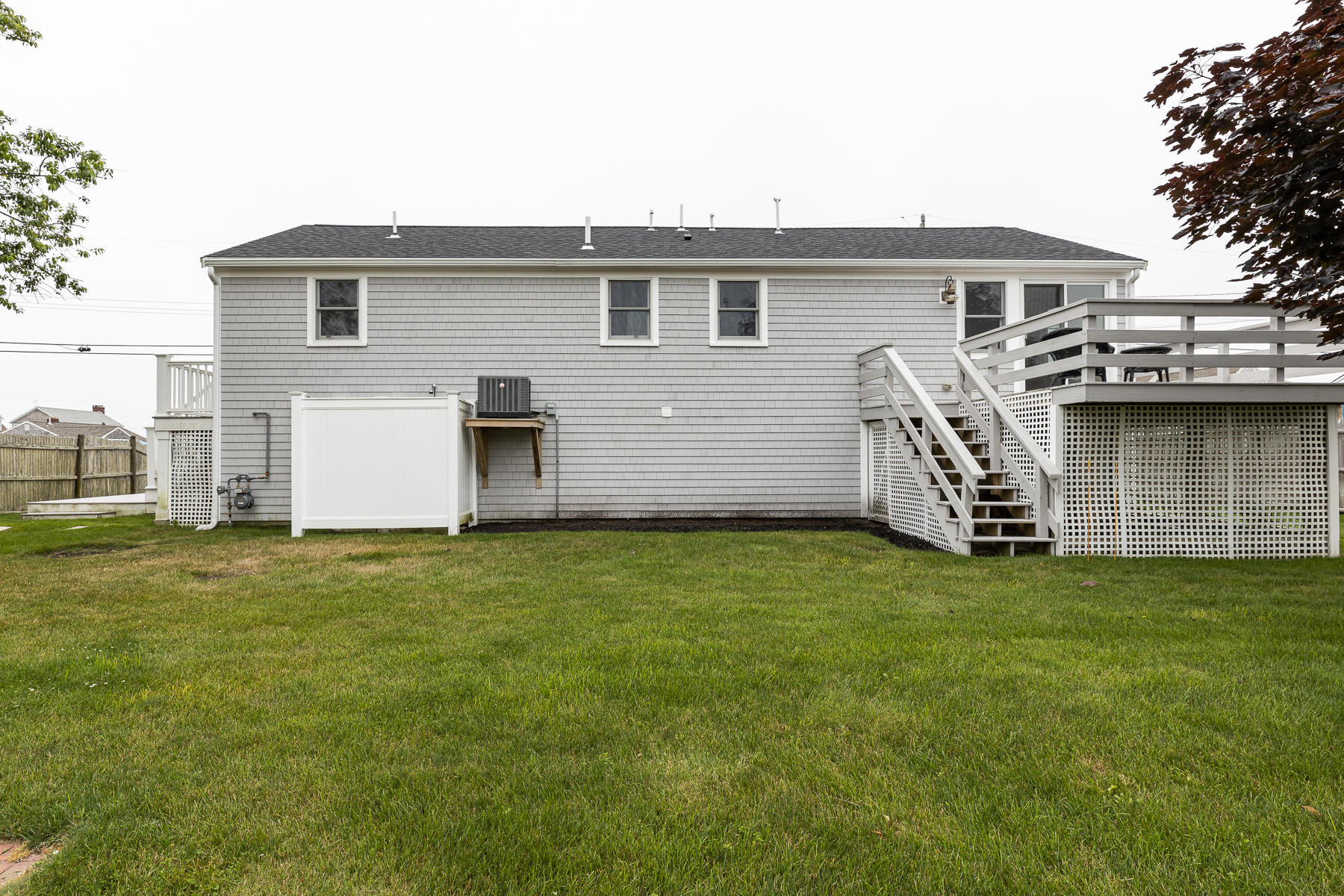 46 Surfside Road West Dennis, MA 02670 - Photo 28 of 32 a backyard of a house with lots of green space
