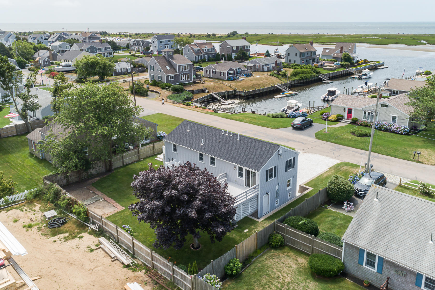 46 Surfside Road West Dennis, MA 02670 - Photo 7 of 32 an aerial view of lake residential houses with outdoor space and seating area