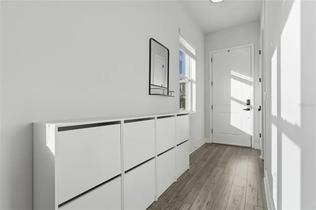a view of a hallway with wooden floor