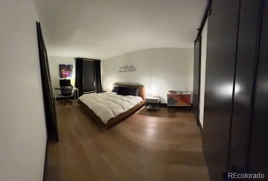 a bedroom with a bed and a mirror