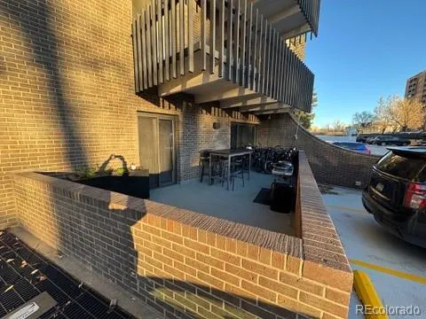 a view of a patio with dining table and chairs with wooden floor
