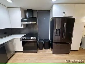 a kitchen with a refrigerator and a sink