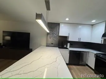 a kitchen with a sink cabinets and stainless steel appliances
