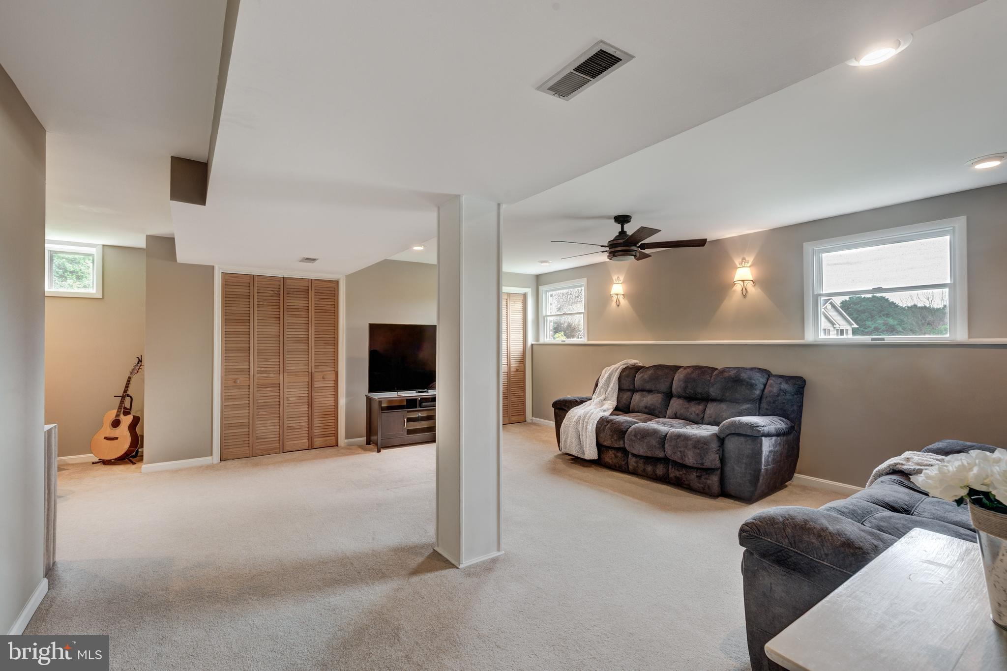 312 Inverness Close Westminster, MD 21158 - Photo 22 of 36 a living room with furniture gym equipment and a flat screen tv