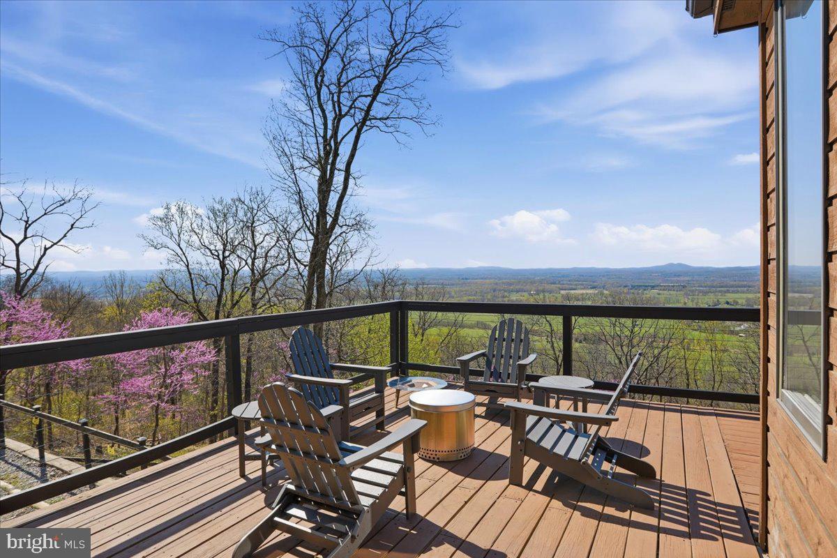 19897 Foresthill Road Bluemont, VA 20135 - Photo 9 of 39 a view of a balcony with chairs and wooden floor