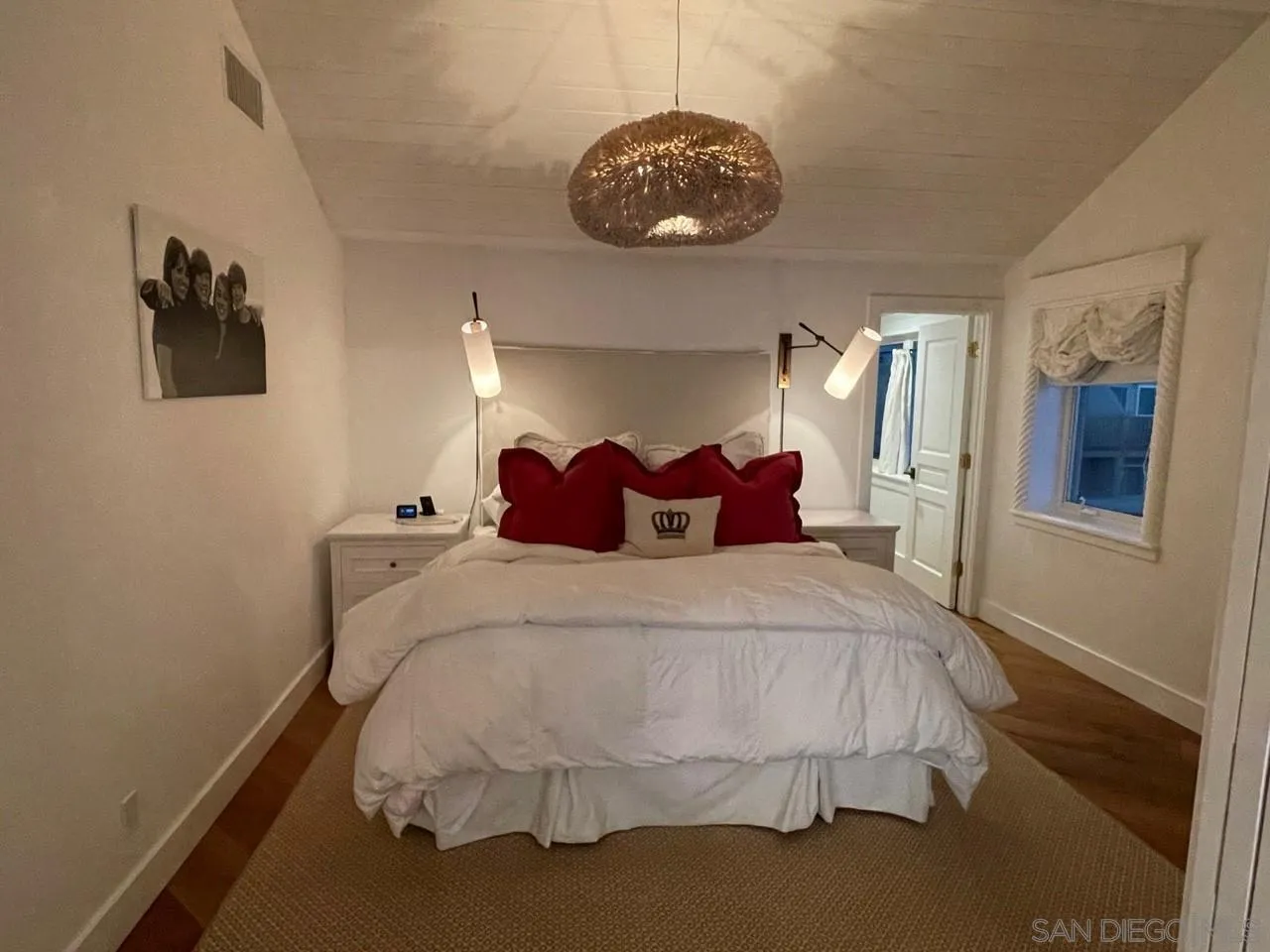 666 Ocean Lane Imperial Beach, CA 91932 - Photo 10 of 15 a spacious bedroom with a bed and chandelier