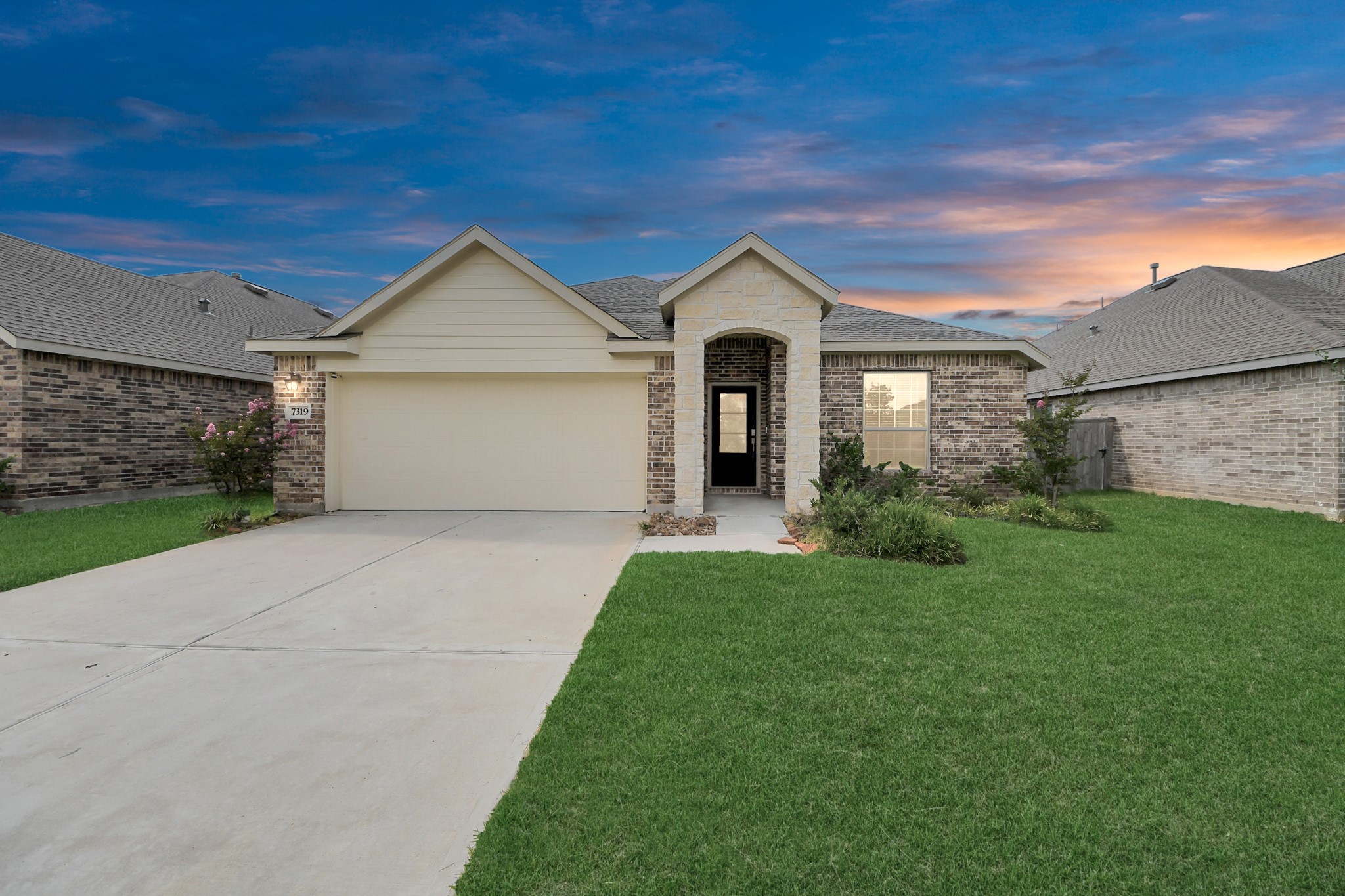 a front view of a house with a yard and garage