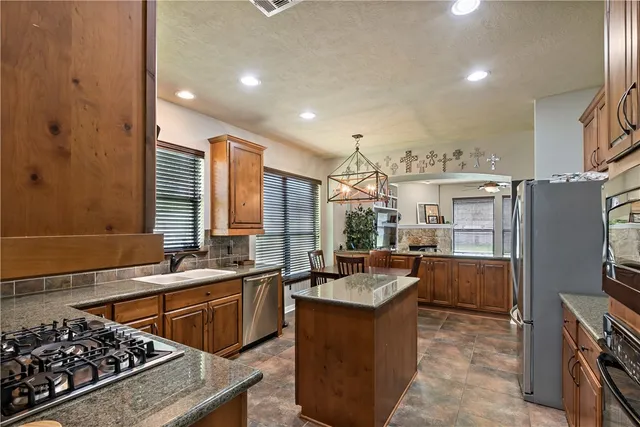 a kitchen with a sink stove and wooden cabinets