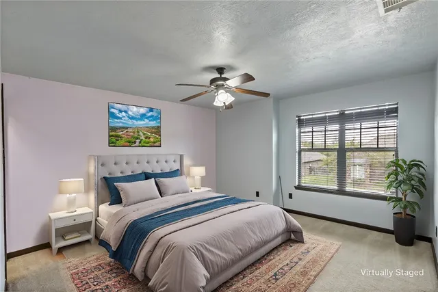 a bedroom with a bed and a potted plant