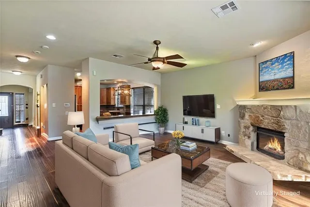 a living room with furniture a fireplace and a flat screen tv