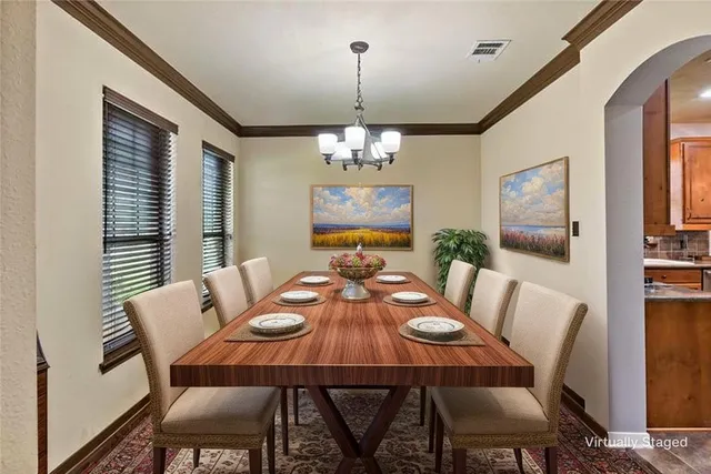 a view of a dining room with furniture and chandelier