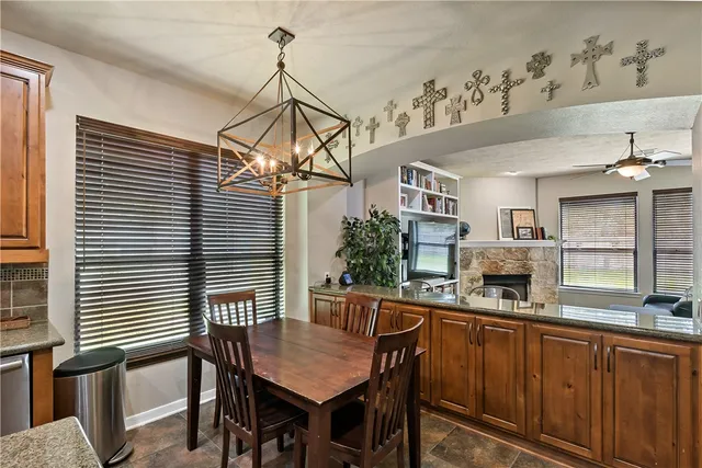 a kitchen with a table chairs and microwave