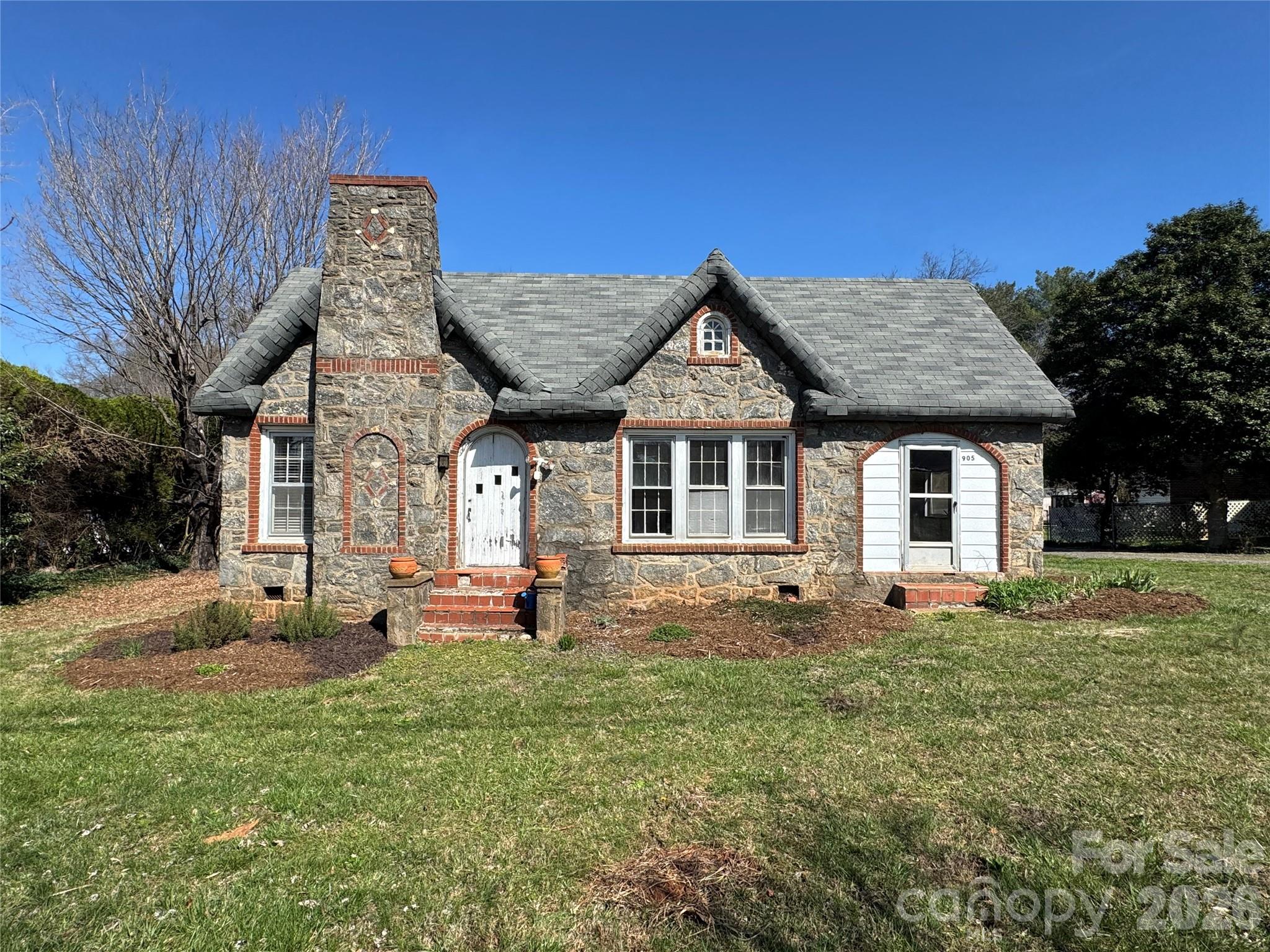 905 Conover Boulevard East Conover, NC 28613 - Photo 22 of 39 a front view of a house with a garden and yard