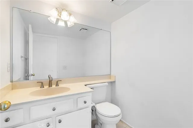 a view of an empty room with stairs and a view of living room