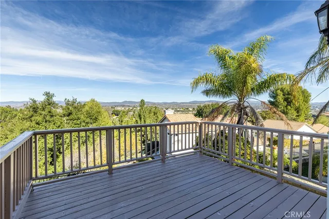 a view of a balcony with wooden floor