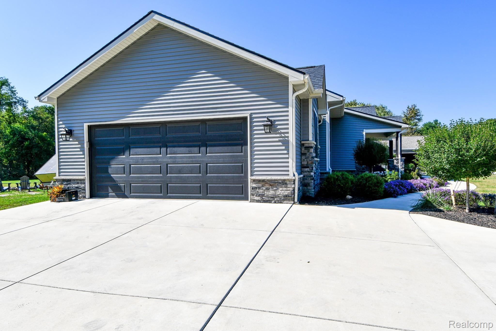 10122 Bennett Lake Road Fenton, MI 48430 - Photo 53 of 56 SIDE ENTRANCE 2+ CAR GARAGE! ENOUGH ROOM IN GARAGE FOR A REFRIGERATOR!