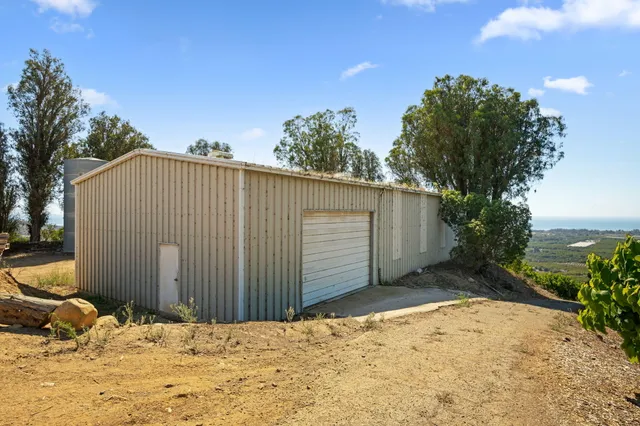 a view of a lush green hillside and houses