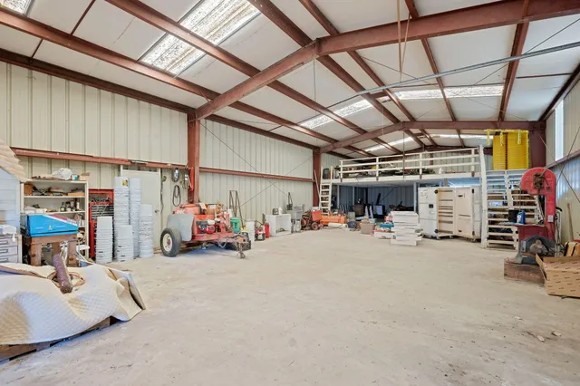 an aerial view of residential house with outdoor space and trees all around