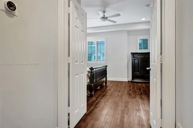 a bedroom with a bed window and a flat screen tv