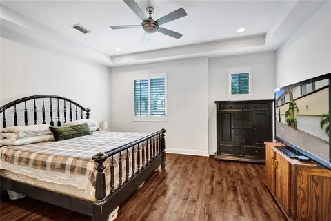 a bedroom with a bed and a painting on the wall