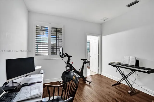 a bedroom with a bed window and a flat screen tv