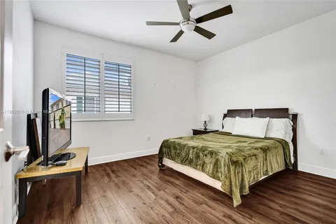 a bedroom with a bed and a lamp on table