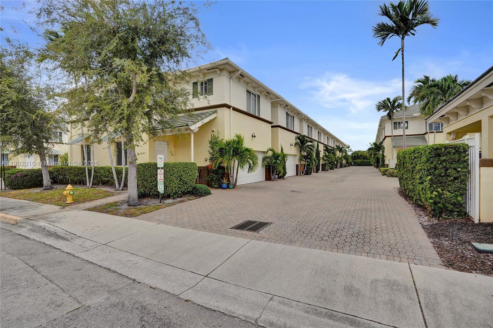518 North Federal Highway, Unit 14 Lake Worth, FL 33460 - Photo 43 of 54 a view of a white house with a yard and palm trees